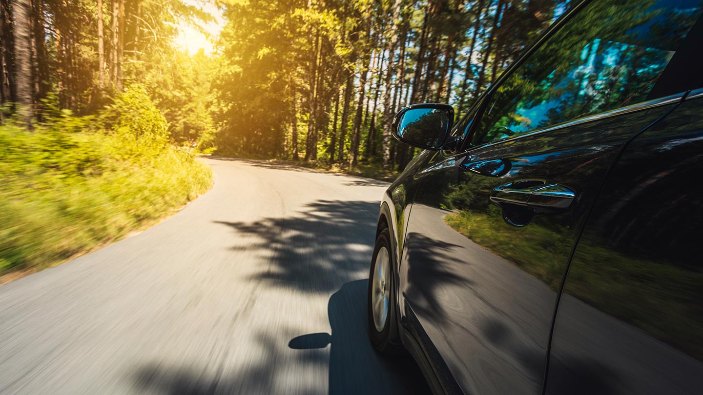 Black car driving on road